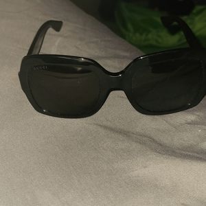 A pair of Gucci Designer Sunglesses.